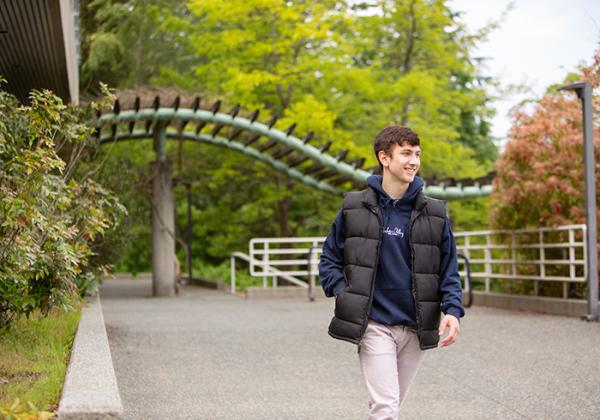 A young man walking outside